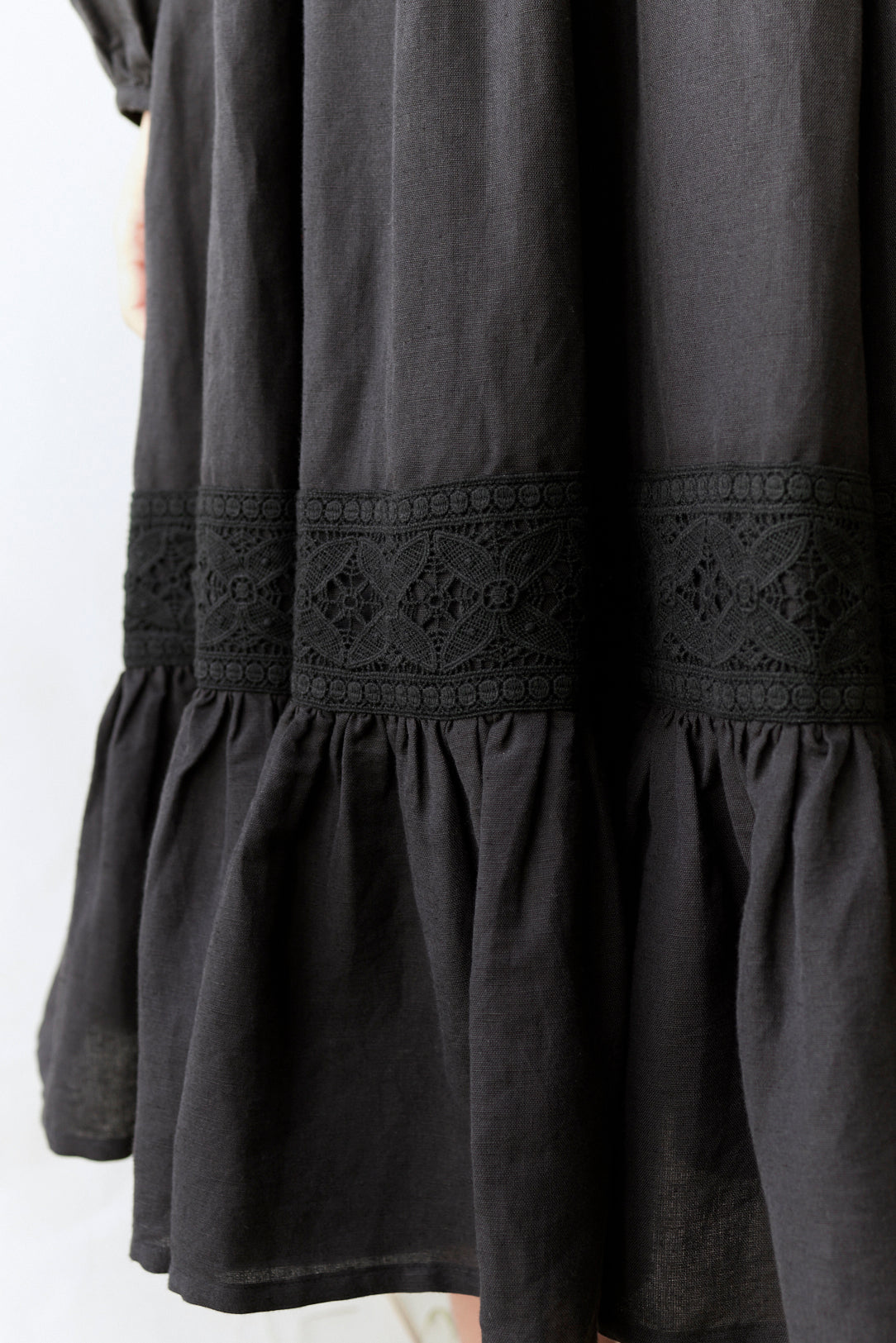 Black dress with lace detailing on a white background