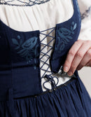 Navy blue Bunad dress with floral embroidery on a white background